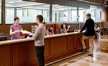 Receptionist helping clients at the front desk