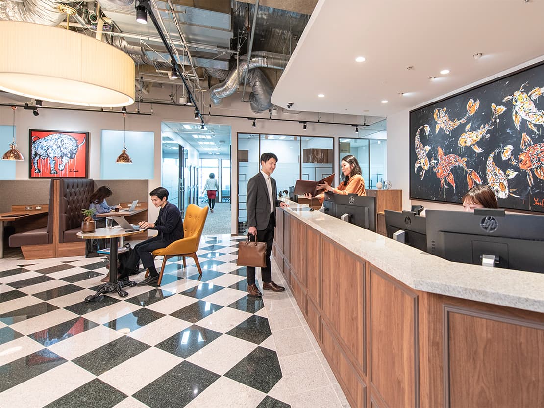 Man talking with secretary at Servcorp reception