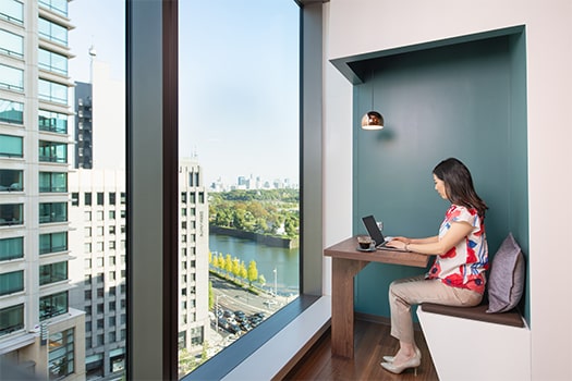 Woman working in a coworking space with a view