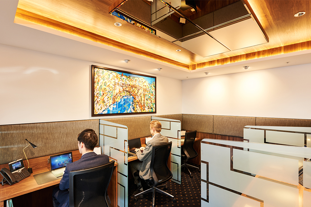Business persons using Servcorp Osaka's Twin 21 hot desk